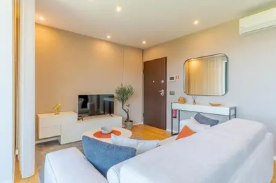 a living room with a white couch and a table at Renala III, by Pausa Holiday Rentals in Funchal