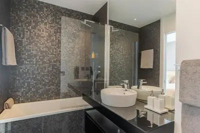 a bathroom with two sinks and a shower at Renala III, by Pausa Holiday Rentals in Funchal