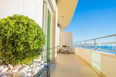 a balcony with potted plants on a building at Rodamar Penthouse in Funchal