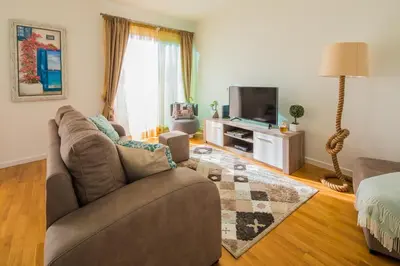 a living room with a couch and a tv at Rodamar Penthouse in Funchal