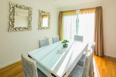 a dining room table with chairs and a mirror at Rodamar Penthouse in Funchal