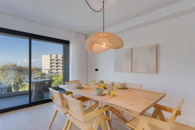 a dining room with a wooden table and chairs at Stay In S.Lucas Residence, by Pausa H. Rentals in Funchal
