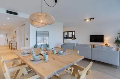 a dining room and living room with a wooden table at Stay In S.Lucas Residence, by Pausa H. Rentals in Funchal