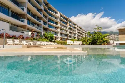 a swimming pool in front of a building at GuestReady - Elegant Madeira Retreat in Funchal