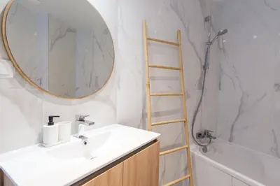 a bathroom with a sink and a mirror at GuestReady - Elegant Madeira Retreat in Funchal