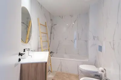 a bathroom with a sink and a toilet and a tub at GuestReady - Elegant Madeira Retreat in Funchal