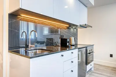 a kitchen with white cabinets and a sink at BSE15 Apartments 2D, a Home in Madeira in Funchal