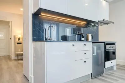 a kitchen with white cabinets and a stove at BSE15 Apartments 3G, a Home in Madeira in Funchal