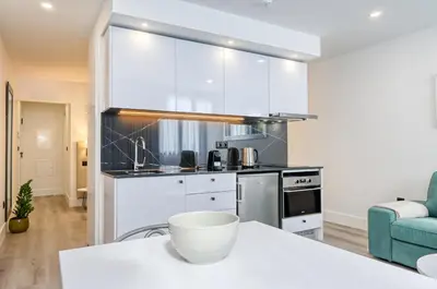 a kitchen with white cabinets and a white counter top at BSE15 Apartments 3G, a Home in Madeira in Funchal