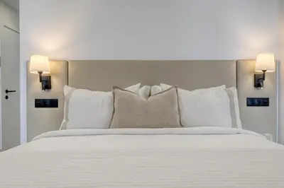 a bedroom with a white bed with pillows at BSE15 Apartments 4J, a Home in Madeira in Funchal
