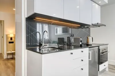 a kitchen with white cabinets and stainless steel appliances at BSE15 Apartments 4J, a Home in Madeira in Funchal