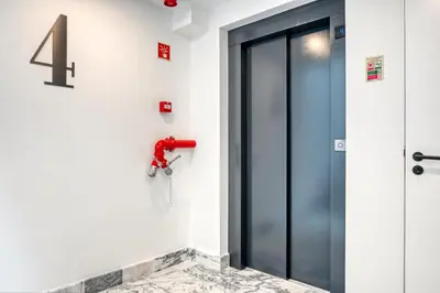 an elevator door with a number four on the wall at BSE15 Apartments 4J, a Home in Madeira in Funchal