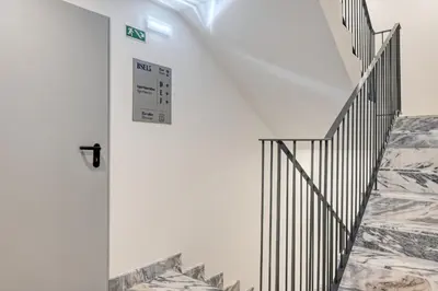 a stairway with a white wall and a white door at BSE15 Apartments 2E, a Home in Madeira in Funchal
