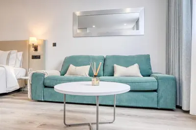 a living room with a green couch and a table at BSE15 Apartments 3H, a Home in Madeira in Funchal