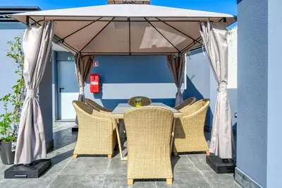 a table and chairs under a gazebo on a patio at BSE15 Apartments 4K, a Home in Madeira in Funchal
