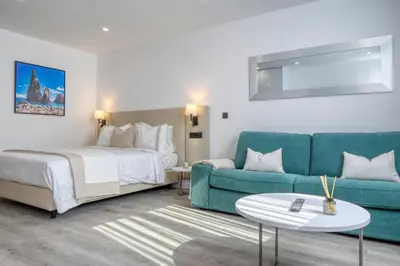 a hotel room with a bed and a couch at BSE15 Apartments 4K, a Home in Madeira in Funchal