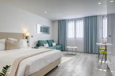 a hotel room with a bed and a couch at BSE15 Apartments 4K, a Home in Madeira in Funchal
