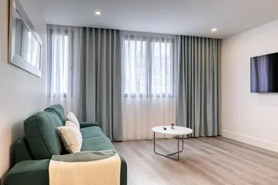 a living room with a green couch and a table at BSE15 Apartments 2F, a Home in Madeira in Funchal