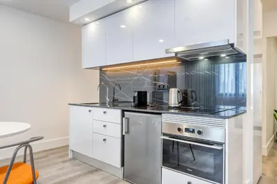 a kitchen with white cabinets and stainless steel appliances at BSE15 Apartments 2F, a Home in Madeira in Funchal