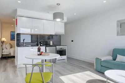 a kitchen and living room with a table and a couch at BSE15 Apartments 4L, a Home in Madeira in Funchal