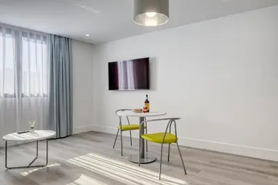 a dining room with a table and yellow chairs at BSE15 Apartments 4L, a Home in Madeira in Funchal