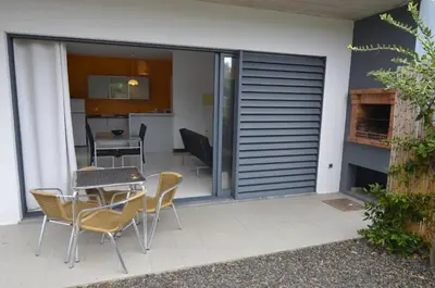 a patio with a table and chairs and a kitchen at Vilas Espírito Santo in Porto Santo