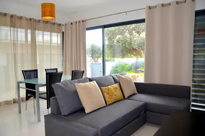 a living room with a couch and a table at Vilas Espírito Santo in Porto Santo