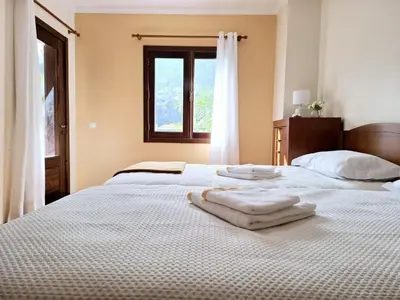 a bedroom with two white towels on a bed at Quartos em Vila Paradise Porto da Cruz in Porto da Cruz