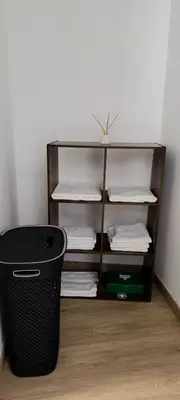 a trash can sitting next to a shelf with towels at Casa Isa - Funchal in Funchal