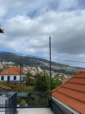 a view of a city from the balcony of a house at Casa Isa - Funchal in Funchal