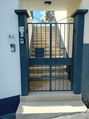 a blue door with a staircase in a building at Casa Isa - Funchal in Funchal