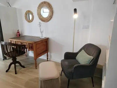 a living room with a chair and a desk at MerakiHouse in Funchal