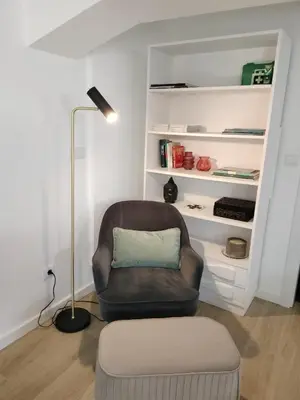 a living room with a chair and a lamp at MerakiHouse in Funchal