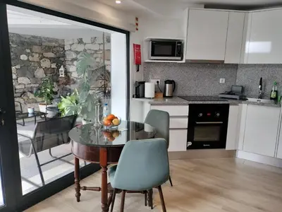 a kitchen with a table and a dining room at MerakiHouse in Funchal