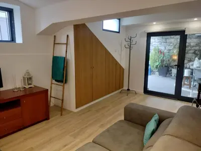 a living room with a couch and a staircase at MerakiHouse in Funchal
