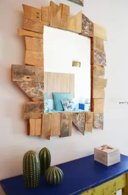 a mirror on a wall next to a table with a cactus at Wanderlust - Beautiful Villa in Aljezur in Aljezur