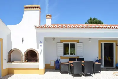 a white house with a table and chairs at Wanderlust - Beautiful Villa in Aljezur in Aljezur