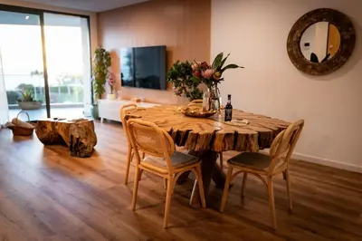 a dining room with a wooden table and chairs at Varandas do Atlântico in Câmara de Lobos