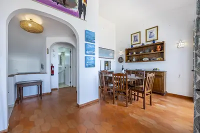 a kitchen and dining room with a table and chairs at CoolHousesAlgarve Luz, 3 bed linked house, pool, superb panoramic sea view, Casa das Buganvílias in Luz