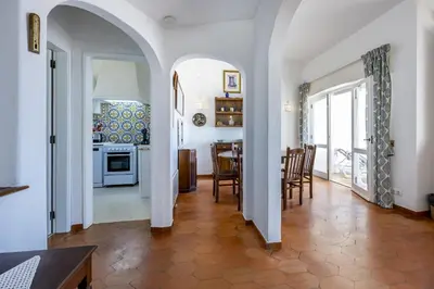 a kitchen and dining room with a table and chairs at CoolHousesAlgarve Luz, 3 bed linked house, pool, superb panoramic sea view, Casa das Buganvílias in Luz
