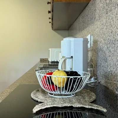 a bowl of fruit sitting on top of a kitchen counter at Green House in Calheta