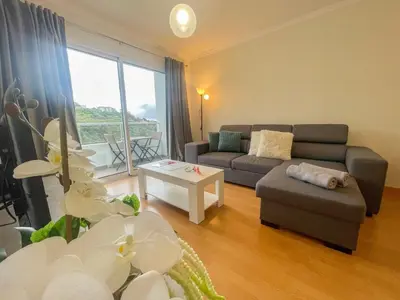 a living room with a couch and a table at Sandie's Serene Stay in Caniço