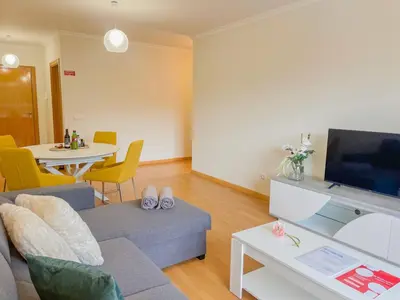 a living room with a couch and a table at Sandie's Serene Stay in Caniço