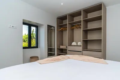 a bedroom with a white bed and a window at Star House -Jacuzzi & Aircon in Calheta