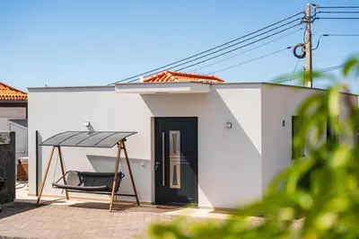 a house with a black door and a black swing at Star House -Jacuzzi & Aircon in Calheta