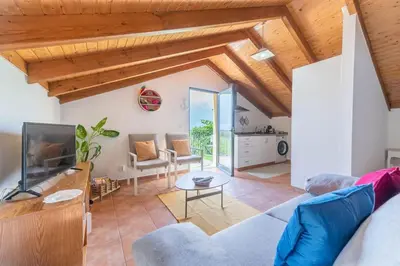 a living room with a bed and a couch at Little Escape Madeira in Ponta Delgada