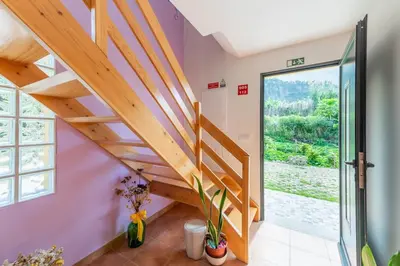 a bedroom with a bed and a table at Little Escape Madeira in Ponta Delgada