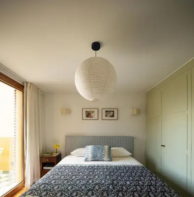 a bedroom with a bed and a large pendant light at Carmo 33 in Funchal