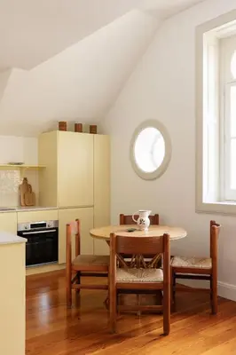 a kitchen with a table and chairs in a room at Carmo 33 in Funchal