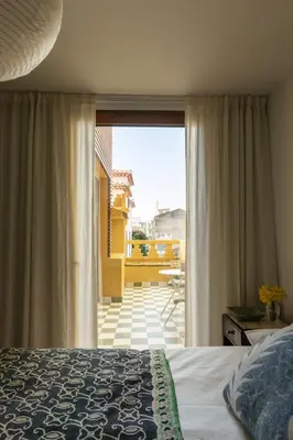 a bedroom with a bed and a large window at Carmo 33 in Funchal